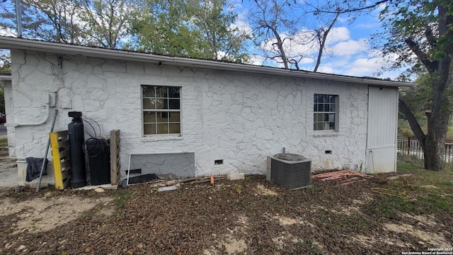 back of house with central air condition unit