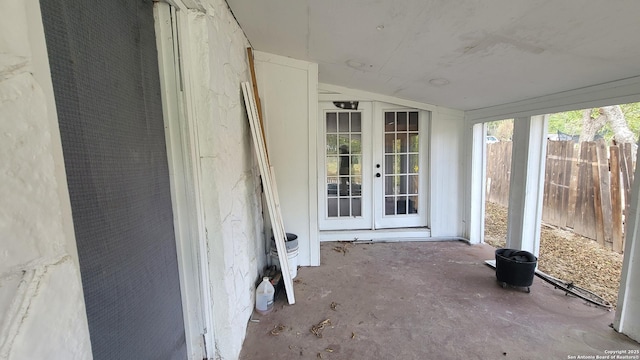 unfurnished sunroom featuring french doors