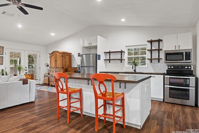 kitchen featuring tasteful backsplash, sink, white cabinetry, stainless steel appliances, and french doors