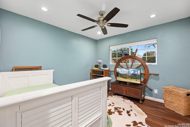 bedroom with ceiling fan and dark hardwood / wood-style flooring