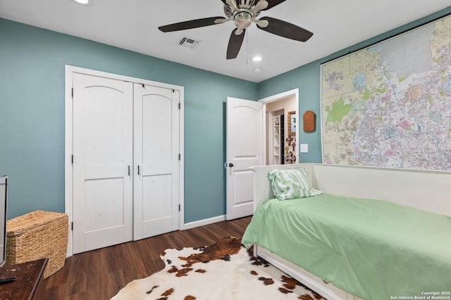 bedroom featuring ceiling fan, a closet, and dark hardwood / wood-style floors