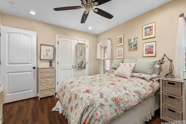 bedroom with ceiling fan, dark hardwood / wood-style floors, and a closet