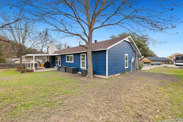 rear view of property featuring a yard and a patio