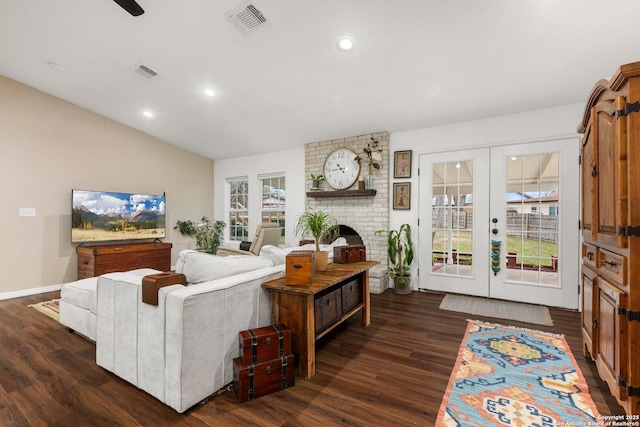 living room with dark hardwood / wood-style floors, a healthy amount of sunlight, and french doors