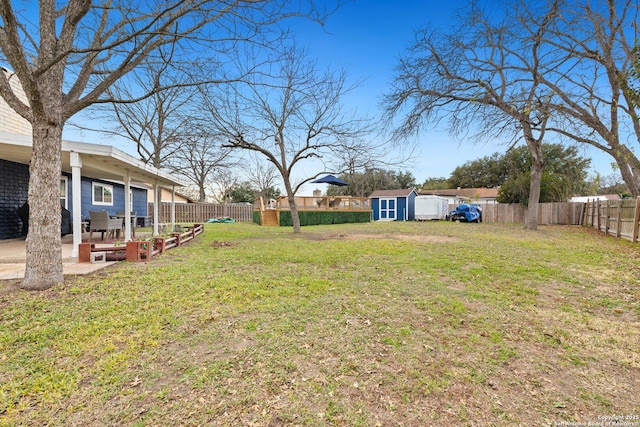 view of yard with a patio and a shed