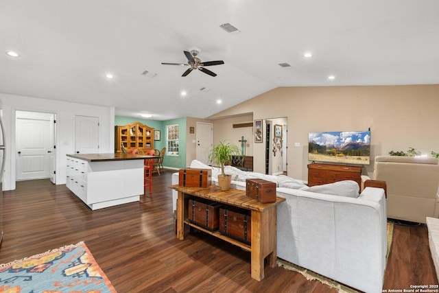 living room featuring ceiling fan, dark hardwood / wood-style floors, and lofted ceiling