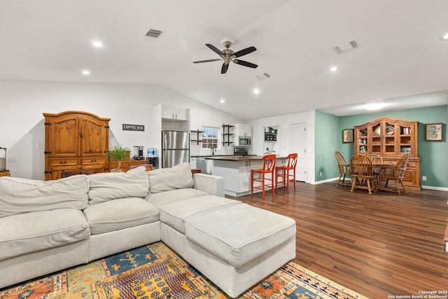 living room featuring ceiling fan, vaulted ceiling, and dark hardwood / wood-style flooring