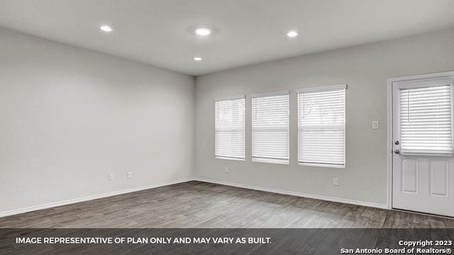 unfurnished room with hardwood / wood-style flooring