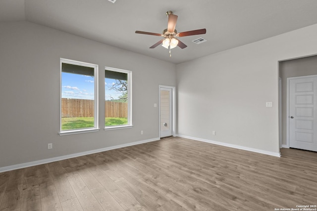 empty room featuring ceiling fan, lofted ceiling, and light hardwood / wood-style floors