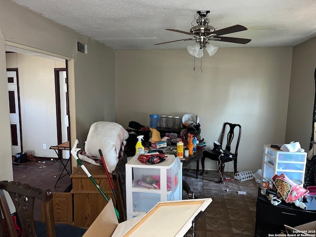 dining room with ceiling fan and a textured ceiling