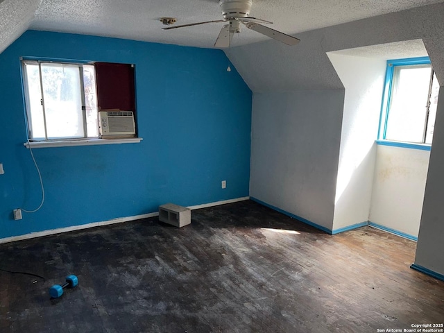 bonus room with ceiling fan, vaulted ceiling, a textured ceiling, and hardwood / wood-style floors