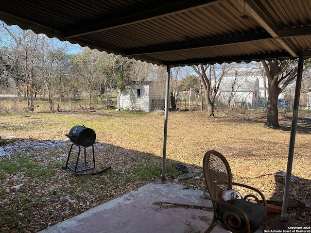 view of yard with a storage unit and a patio