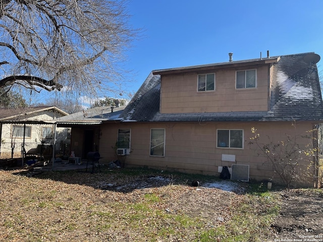 rear view of property with cooling unit