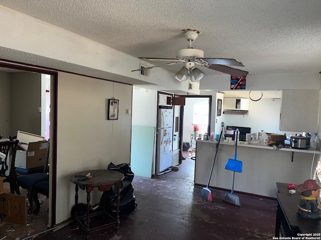 kitchen with ceiling fan, a textured ceiling, and white fridge