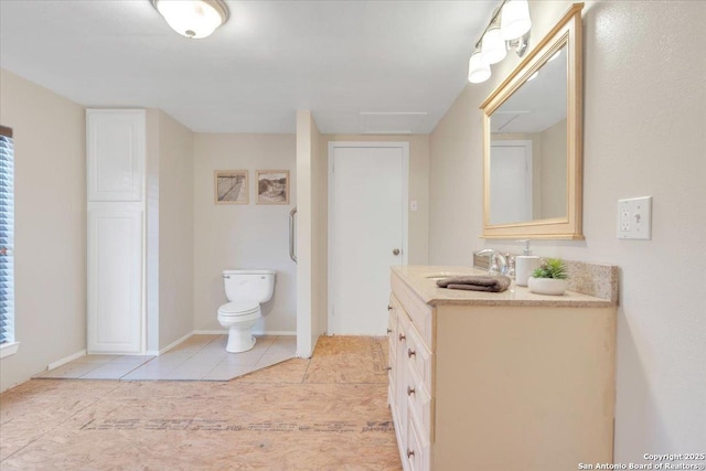 bathroom featuring tile patterned floors, toilet, and vanity