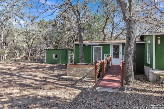 single story home featuring an outbuilding