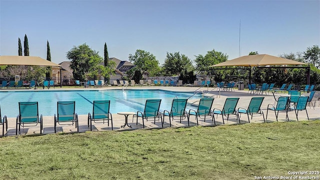 view of pool with a yard