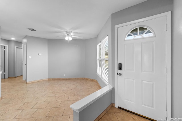 tiled foyer entrance with ceiling fan