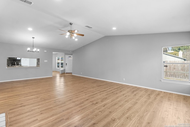 unfurnished living room with lofted ceiling, light wood-type flooring, and ceiling fan with notable chandelier