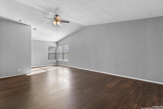 unfurnished room with ceiling fan, vaulted ceiling, and dark wood-type flooring