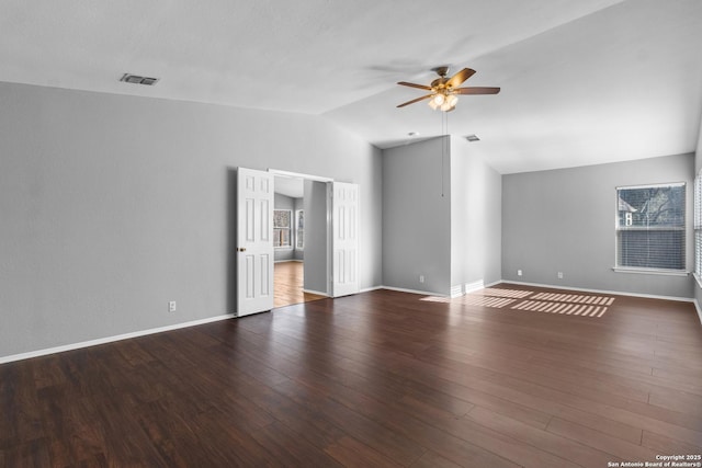 empty room featuring ceiling fan, lofted ceiling, and dark hardwood / wood-style floors