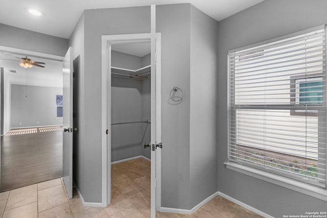 bathroom featuring ceiling fan and tile patterned floors