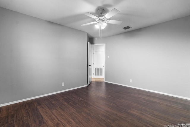 empty room featuring dark wood-type flooring and ceiling fan