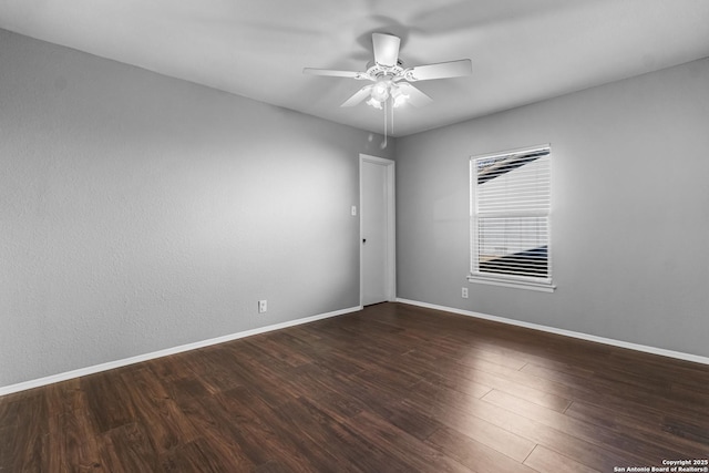 spare room with ceiling fan and dark hardwood / wood-style floors