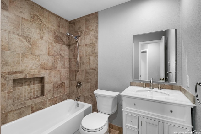 full bathroom featuring toilet, tiled shower / bath, a tiled fireplace, and vanity