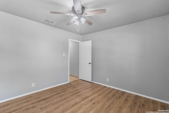 empty room featuring ceiling fan and light hardwood / wood-style floors