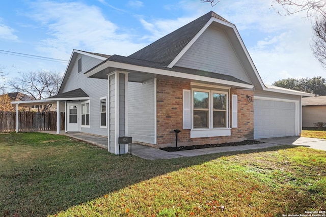 view of side of property with a lawn and a garage