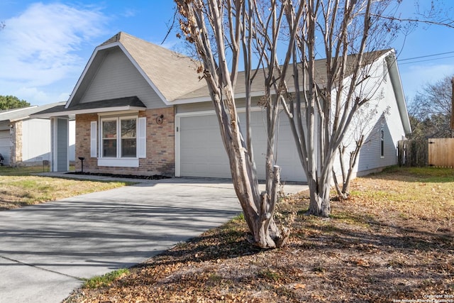 view of front of home with a garage and a front lawn