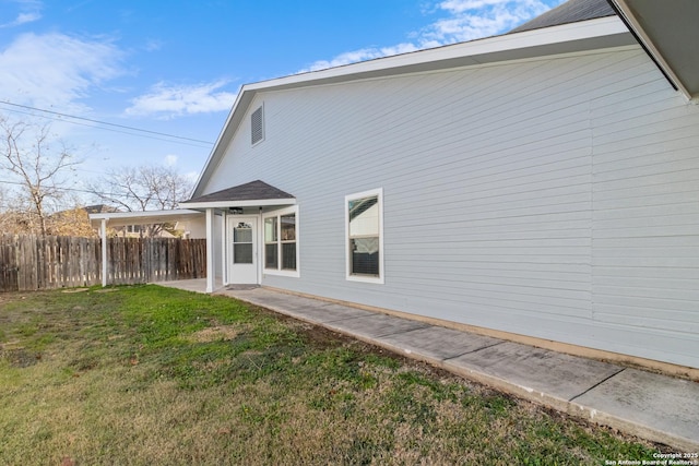 back of house with a patio area and a lawn