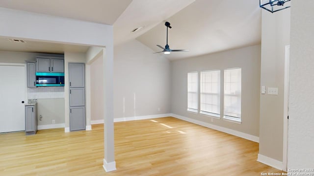 unfurnished living room featuring ceiling fan, lofted ceiling, and wood-type flooring