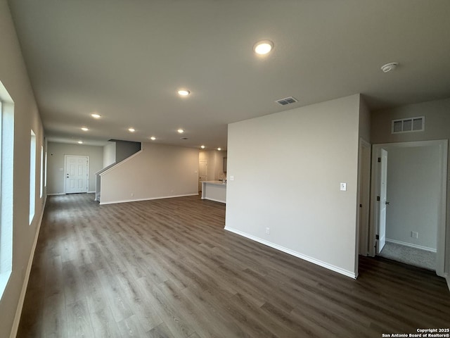 unfurnished living room with dark hardwood / wood-style floors