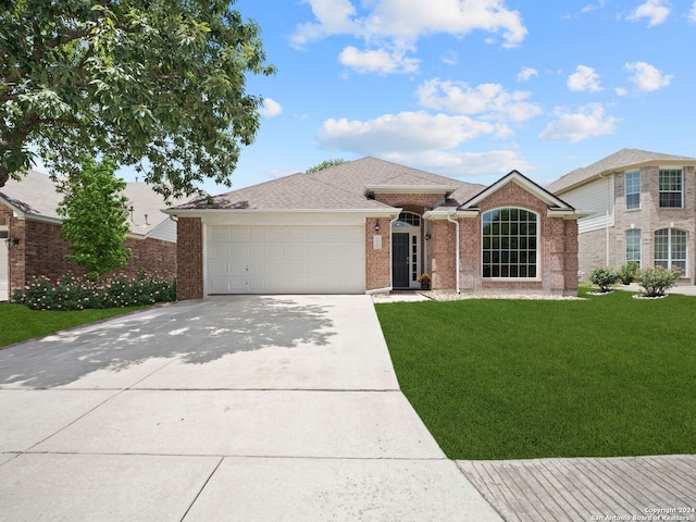 single story home featuring a front yard and a garage