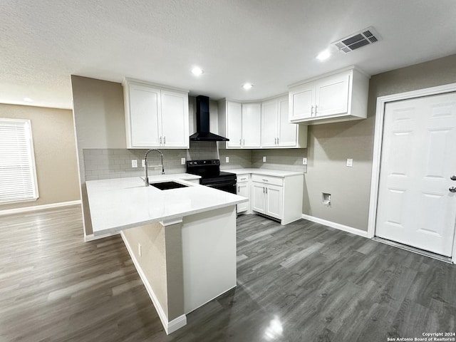 kitchen with dark hardwood / wood-style floors, sink, black electric range oven, white cabinetry, and wall chimney exhaust hood