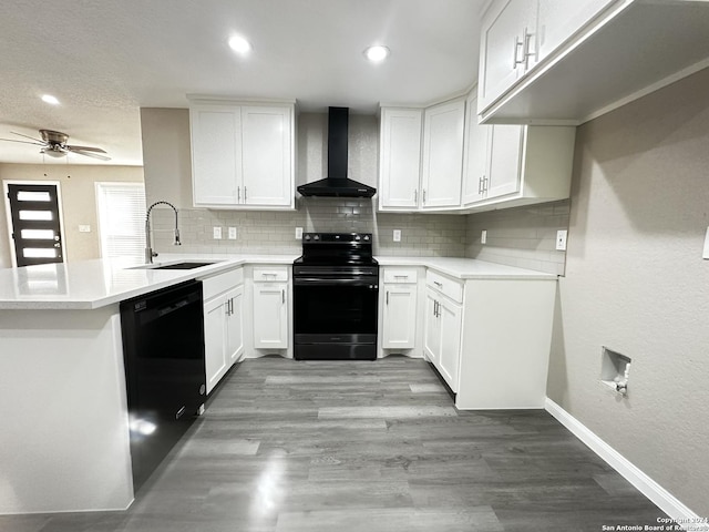 kitchen featuring black appliances, white cabinets, wall chimney exhaust hood, and sink