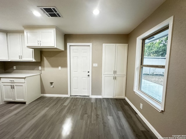 clothes washing area with dark hardwood / wood-style flooring