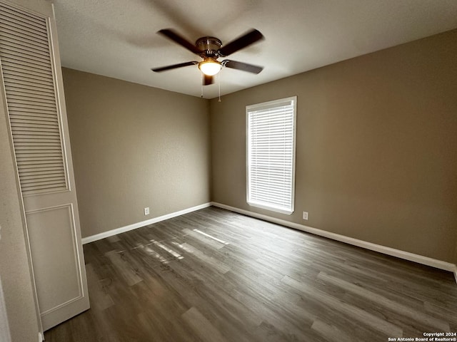 unfurnished room with ceiling fan and dark hardwood / wood-style floors