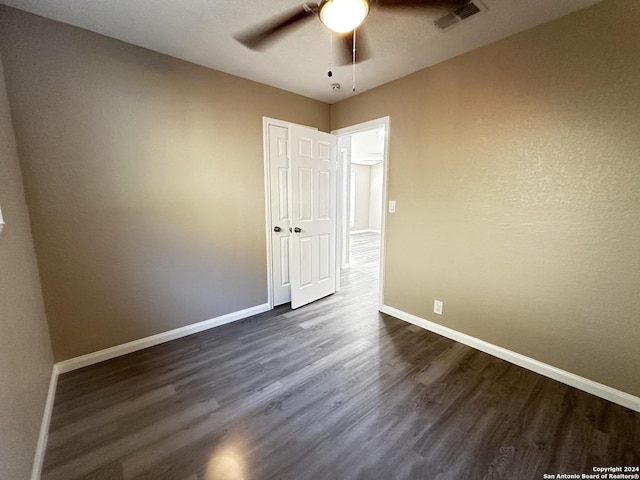 unfurnished room with ceiling fan and dark hardwood / wood-style floors