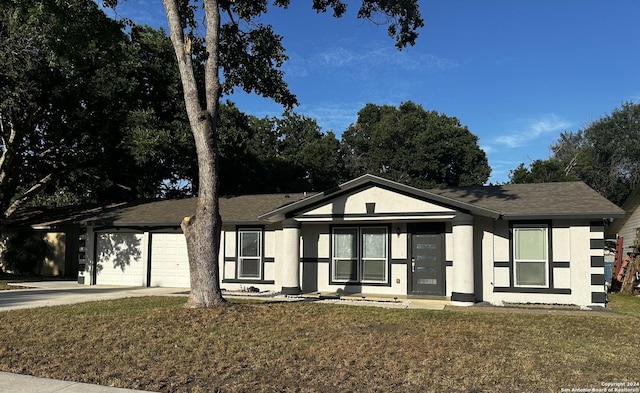 single story home with a garage and a front lawn