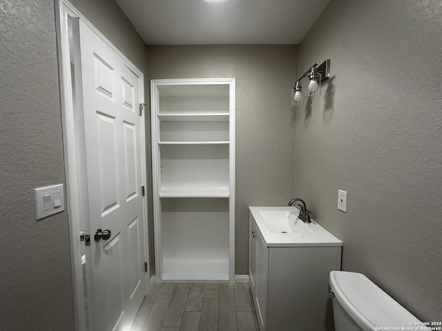 bathroom featuring toilet and vanity