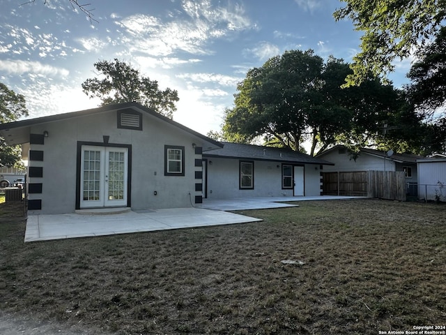 rear view of house featuring a yard and a patio