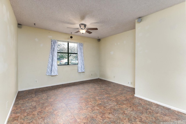 unfurnished room featuring ceiling fan and a textured ceiling