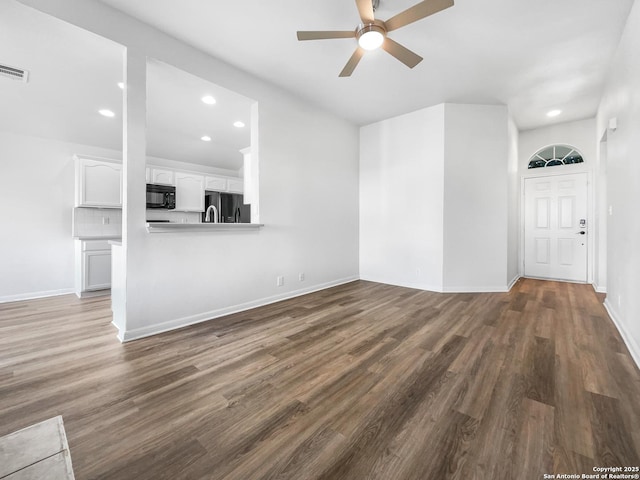 unfurnished living room with wood-type flooring and ceiling fan