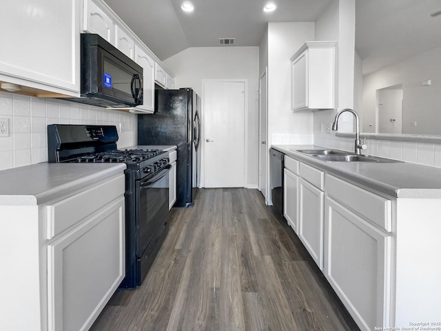 kitchen with white cabinets, black appliances, decorative backsplash, sink, and dark hardwood / wood-style floors