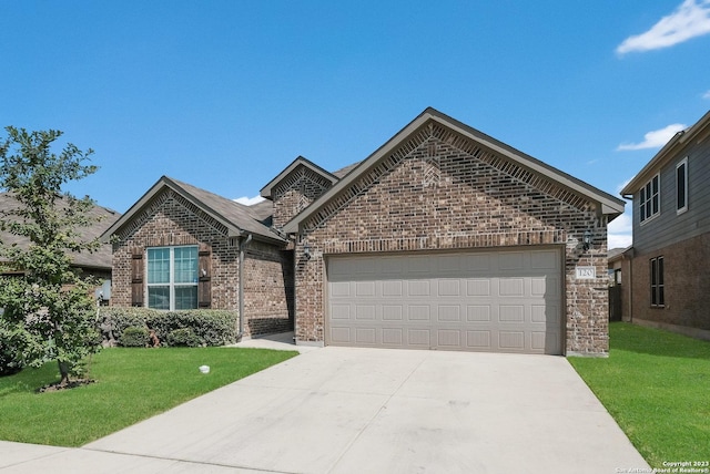 view of front of house featuring a garage and a front lawn