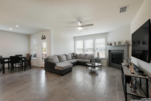 living room featuring ceiling fan and a wealth of natural light