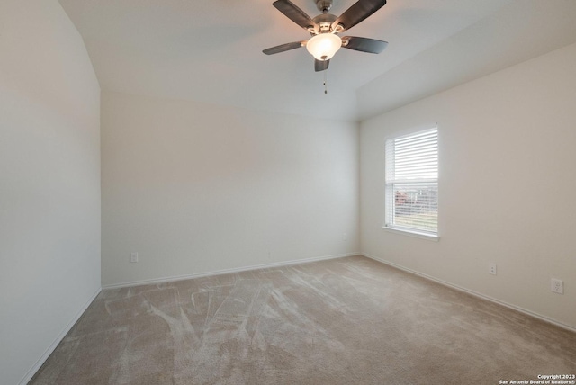 carpeted empty room with ceiling fan and vaulted ceiling